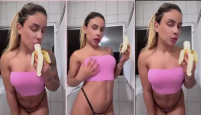 Lusia Fernanda de calcinha e cropped saboreando uma banana